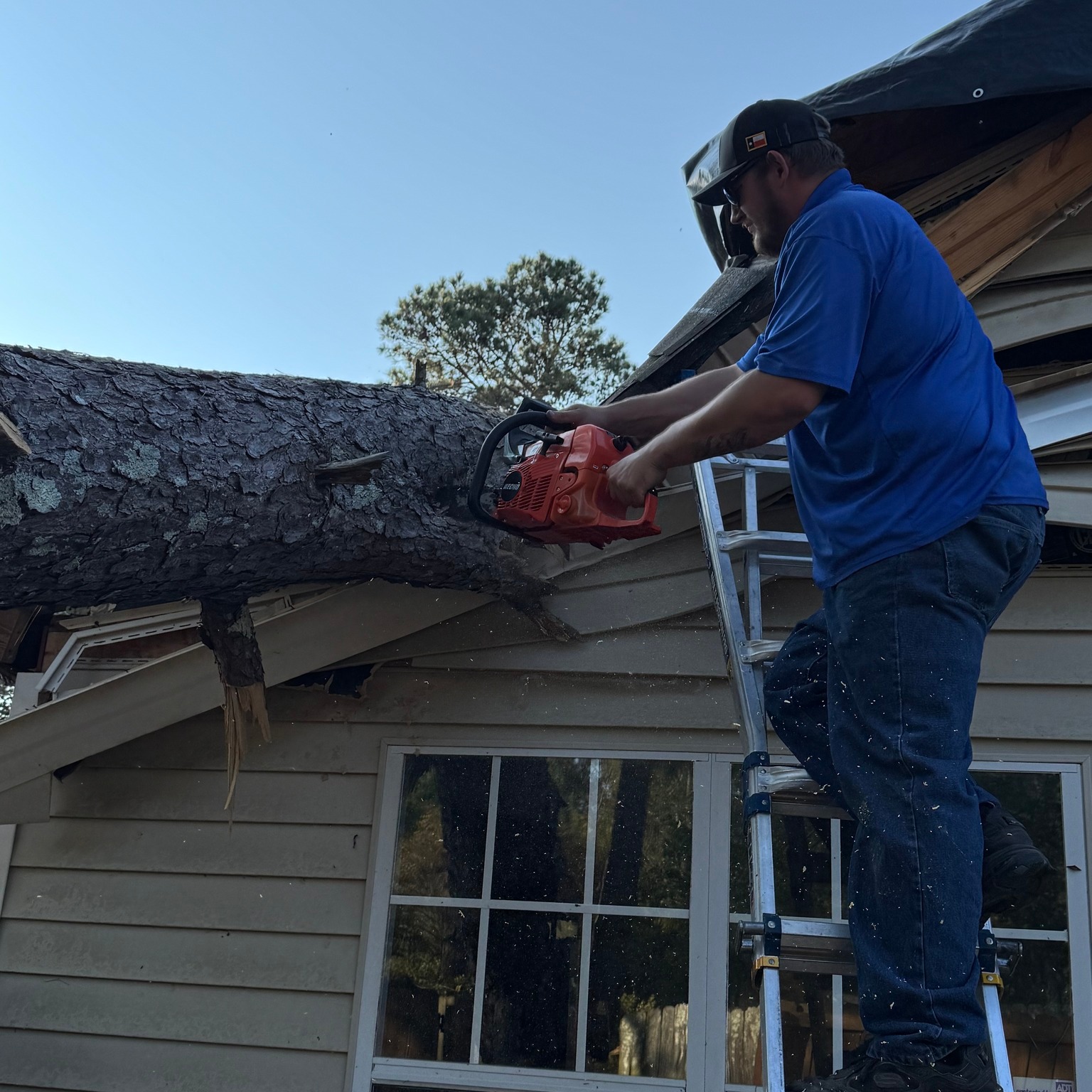 Pro-Craft Restoration technician performing roof repair on a residential property.