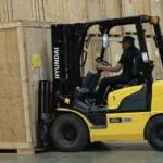 Pro-Craft Restoration technician operating a forklift to move packed contents during contents restoration and storage process.
