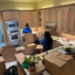 Pro-Craft Restoration technician packing household contents during restoration work.