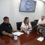 Pro-Craft Restoration leadership team meeting in the office to review projects and coordinate restoration services.