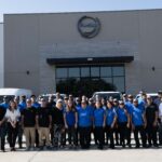 Pro-Craft Restoration team standing in front of their Dallas–Fort Worth headquarters with company vehicles, representing insurance restoration specialists.