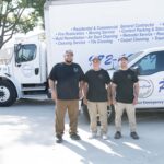 Pro-Craft Restoration technicians standing in front of branded service trucks in Dallas–Fort Worth.