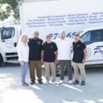 Pro-Craft Restoration team members standing in front of branded service trucks in the Dallas–Fort Worth area.