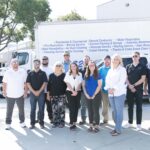 Pro-Craft Restoration office and field team standing in front of branded service trucks in the Dallas–Fort Worth area.